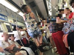 小男孩车厢内爬柱子  家长在一旁“打气”